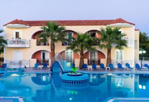 a resort with palm trees and a swimming pool at Hera Zakynthos Hotel in Laganas