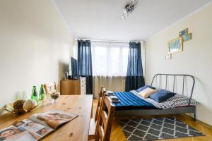 a bedroom with a bed and a wooden table at Premium Key-Apartaments Śródmieście in Warsaw