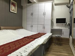 Postel nebo postele na pokoji v ubytování Hong Kong Tai San Guest House (Burlington Branch)