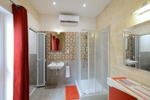 a bathroom with a shower and a sink at Lovely House Private Rooms by Vallettastay in Valletta