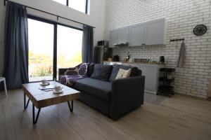 a living room with a couch and a table at Lake Residence in Dunajská Streda