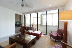 a living room with a couch and a table at Pullman Palm Cove Sea Temple Resort & Spa in Palm Cove