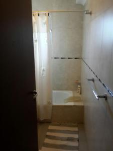 a bathroom with a shower and a sink and a tub at La Rinconada in Las Grutas +12 photos