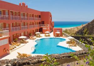 a hotel with a swimming pool next to the beach at Your Ocean Window in Costa Calma