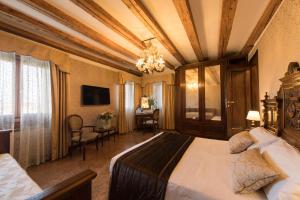 威尼斯的住宿－Palazzo Bembo - Exclusive Accommodation，酒店客房配有一张床铺和一张桌子。