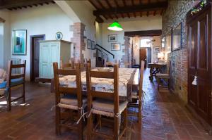 a dining room with a wooden table and chairs at Private pool Villa Wine&cooking -Trasimeno Lake in Panicale