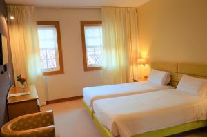 Кровать или кровати в номере Hotel Toural