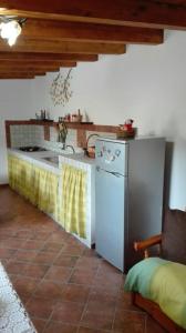 a kitchen with a white refrigerator and a sink at Le casette di Simona in Lampedusa