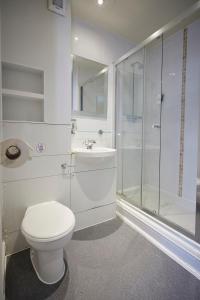 a bathroom with a toilet and a shower and a sink at Childwall Abbey, Liverpool by Marston's Inns in Liverpool +18 photos