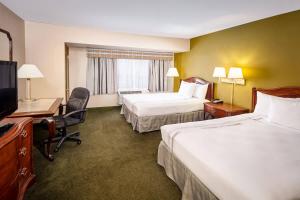 a hotel room with two beds and a desk and a television at Chicago Lakeshore Hotel in Chicago +18 photos