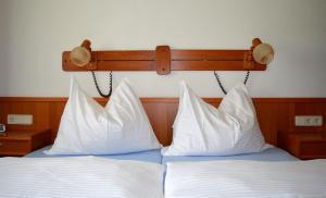 a bed with white pillows and a head board at Appartementhaus Novak in Mariapfarr