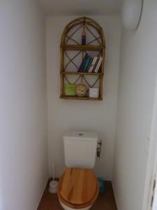 a bathroom with a toilet with a shelf above it at Gîte de Saint Cassien in Montauroux +27 photos