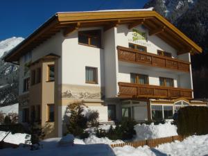 a large building with snow in front of it at Appartement Rauch in Sölden
