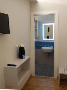 a bathroom with a shower and a sink and a mirror at Ánemos b&b in Termoli