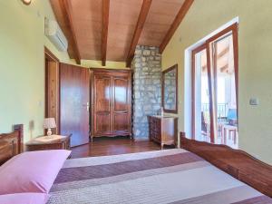 a bedroom with a large bed and a window at Holiday Home Panorama 2 by Interhome in Labin +27 photos