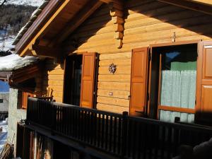 a balcony of a log cabin with a window at Villa Zita in Champoluc