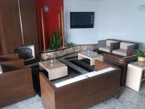 a lobby with couches and a flat screen tv at Style Hotel ( Adults Only) in Sao Paulo