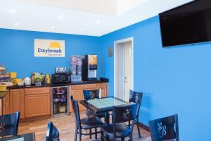 a kitchen with a table, chairs and a microwave at Days Inn by Wyndham New Haven in New Haven