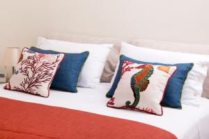 a group of pillows sitting on top of a bed at Villa Claudia in SantʼAgata sui Due Golfi