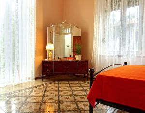 a bedroom with a dresser with a mirror and a bed at Italian flair with a view in Rhodes Town