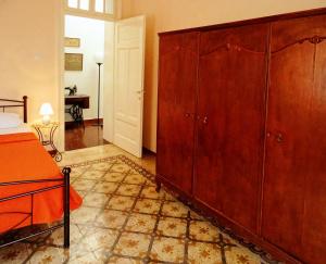 a bedroom with a bed and a large wooden cabinet at Italian flair with a view in Rhodes Town