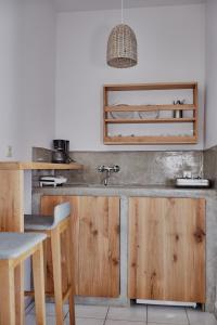 a kitchen with wooden cabinets and a sink at Irene Studios in ayios Petros