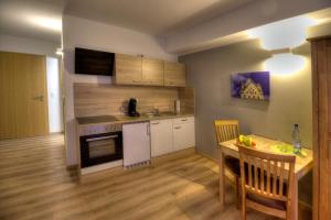 a kitchen and dining room with a table and a dining room at Pader-Motel in Paderborn