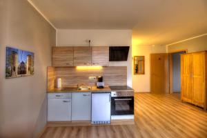 a kitchen with a sink and a stove at Pader-Motel in Paderborn