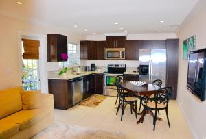 a kitchen and dining room with a table and a couch at Sea Turtle Inn in Vero Beach