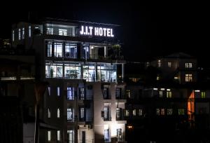 a building with a lit hotel sign on it at night at J. I. T HOTEL in Chaltlāng