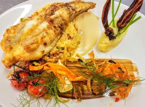 a plate of food with chicken and rice and vegetables at Caisleain Oir Hotel in Annagry