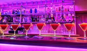 a bar with a bunch of martini glasses on the bar at Caisleain Oir Hotel in Annagry