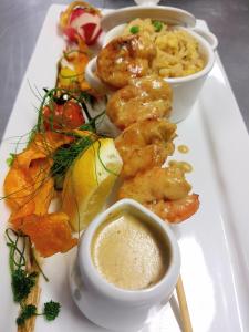a plate of food with shrimp and other foods at Caisleain Oir Hotel in Annagry