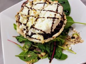 a white plate with a piece of food on a salad at Caisleain Oir Hotel in Annagry