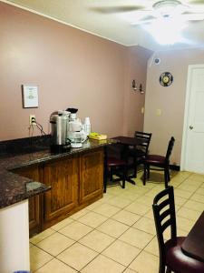 a kitchen with a counter and a table and chairs at Island Inn in Grand Island