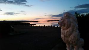 a statue of a lion in front of a sunset at Caisleain Oir Hotel in Annagry