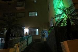 a hallway of a building with a palm tree next to it at La Villa Hotel in Cordeirópolis