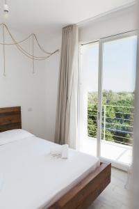 PalagianelloにあるLe Stanze di Melìのベッドルーム1室(ベッド1台、大きな窓付)