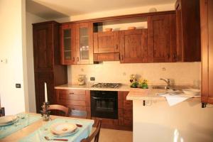 
a kitchen with a stove top oven and a sink at Residence Podere Olmo in Sovicille
