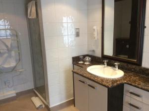 a bathroom with a sink and a shower at The Golden Lion Hotel in Northallerton