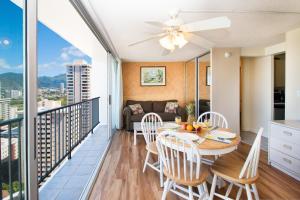 a dining room and living room with a balcony at Ocean View Studio, Near Waikiki Beach in Honolulu