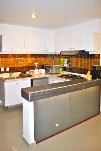 a kitchen with white cabinets and a counter top at Business Suites SG in Mexico City