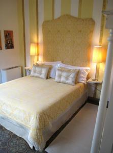 a bedroom with a large bed with two pillows at Fontelunga Hotel & Villas in Pozzo