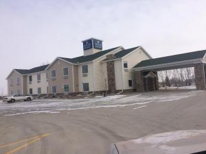 a building with a clock tower on top of it at Cobblestone Inn & Suites Steele in Steele