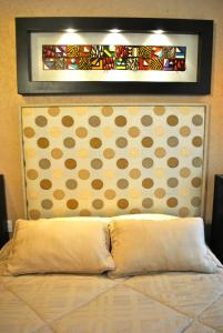メキシコシティにあるBusiness Suites SGのベッドルーム1室(ベッド1台、上に絵画付)