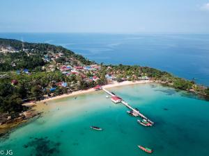 an aerial view of a beach with boats in the water at Easy Tiger - M'Pai Bay Beach, Koh Rong Sanloem in Koh Rong Sanloem