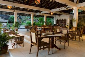 a restaurant with tables and chairs in a room at Minang Cove Resort in Tioman Island