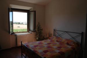 A bed or beds in a room at Agriturismo Pian dei Pini