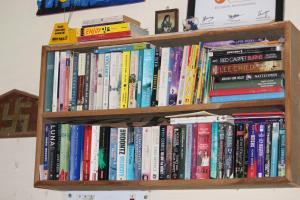 a book shelf filled with lots of books at Hotel Sunset in Orchha