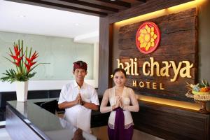 a man and a woman standing in front of a hotel at Bali Chaya Hotel Legian in Legian +29 photos